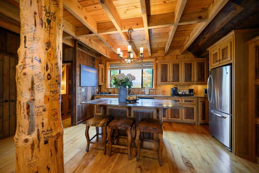 Kitchen with marble island and log beams