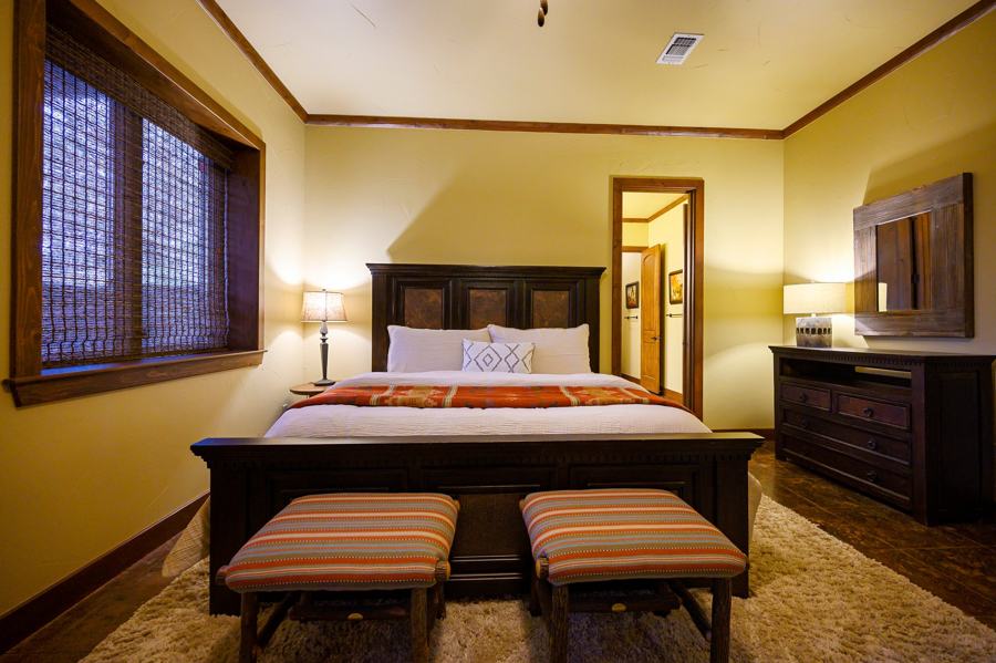 Downstairs king suite with dark wood bed