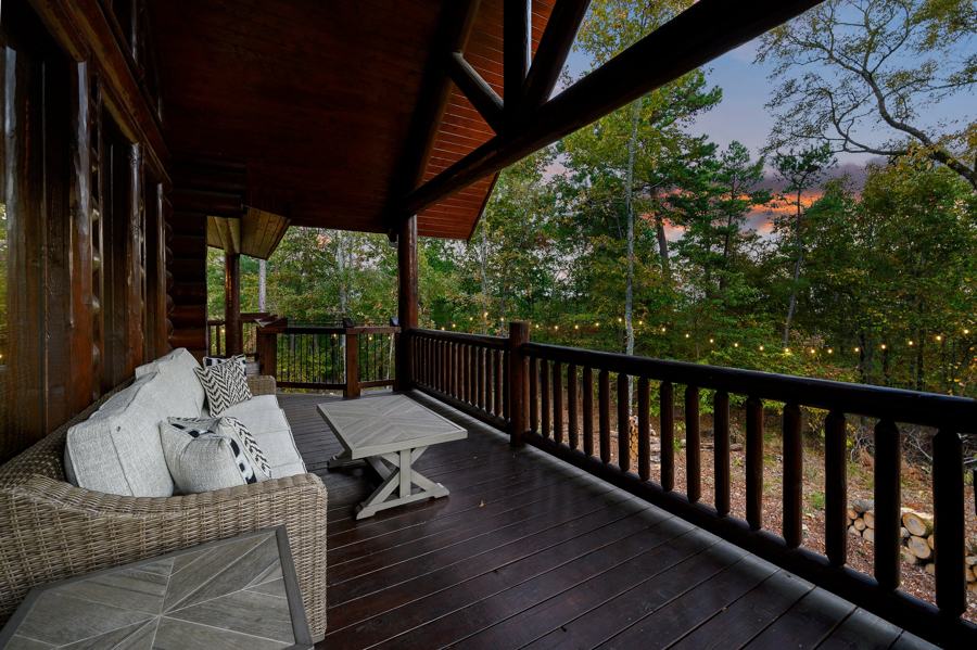 Covered balcony with outdoor sofa above the forest